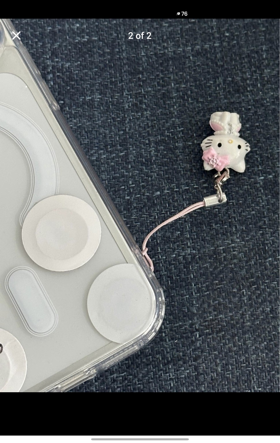 Phone case with round access sticker and decorative phone charm